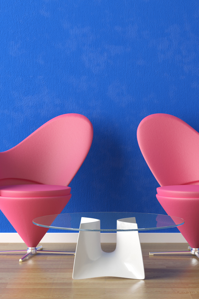 Two pink chairs and a glass table at the blue wall