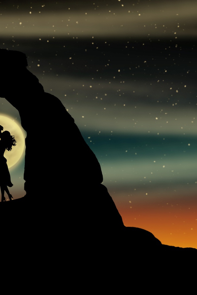 Поцелуй влюбленной пары в горах на фоне луны