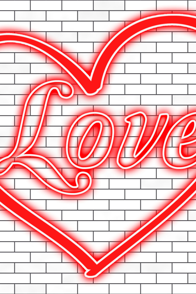 Красное сердце с надписью Любовь на кирпичной стене