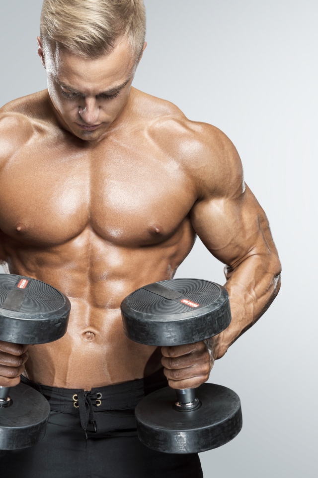 Inflated man with dumbbells in hands on gray background