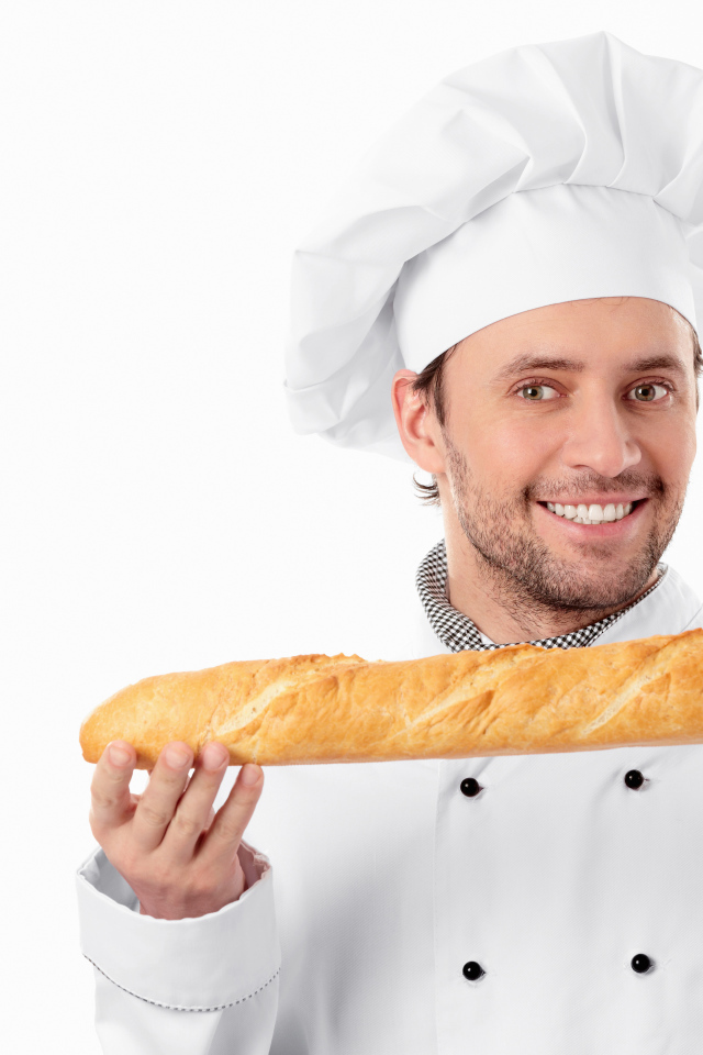 Male cook in a suit with a loaf in his hands