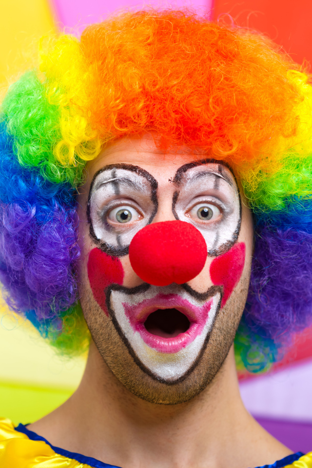 Удивленный мужчина в костюме клоуна 