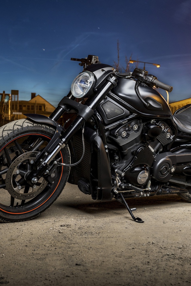 Powerful black motorcycle Harley Davidson standing on the street with a lantern
