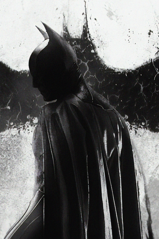 Бэтмен на фоне рисунка летучей мыши на стене