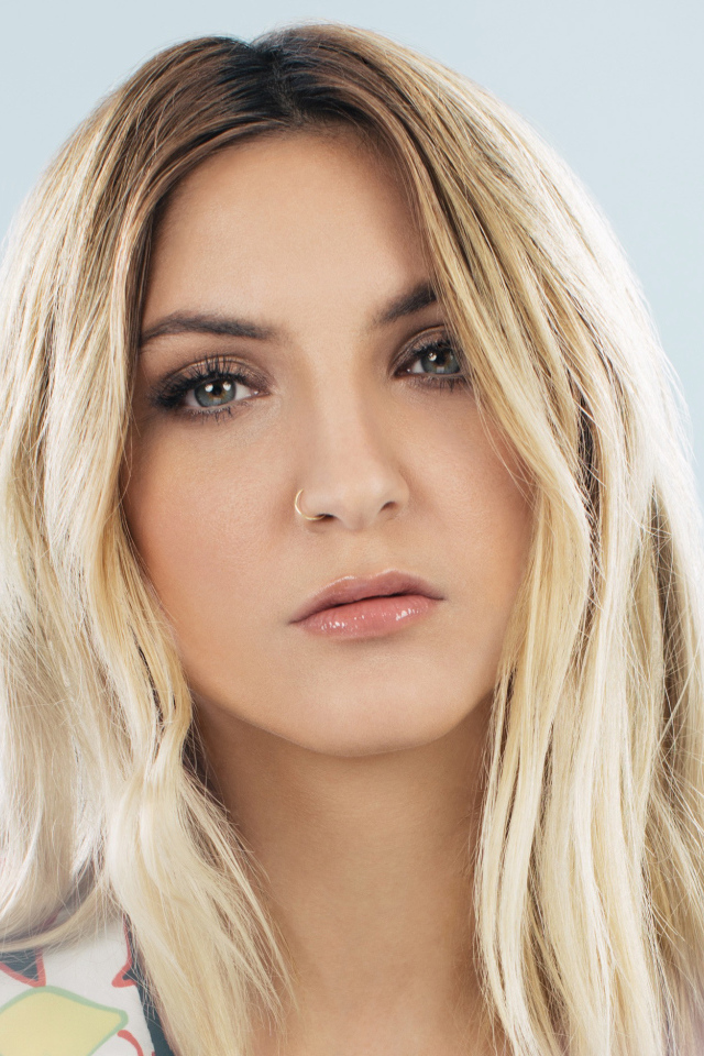 Красивая блондинка, певица Джулия Майклз на сером фоне