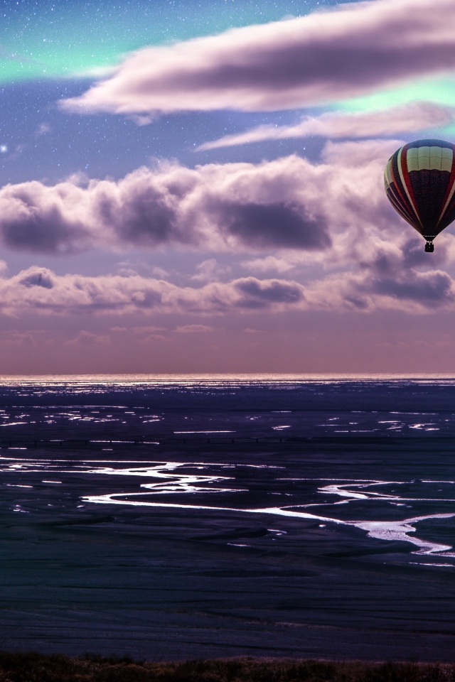 Воздушный шар в небе в белыми облаками над морем 