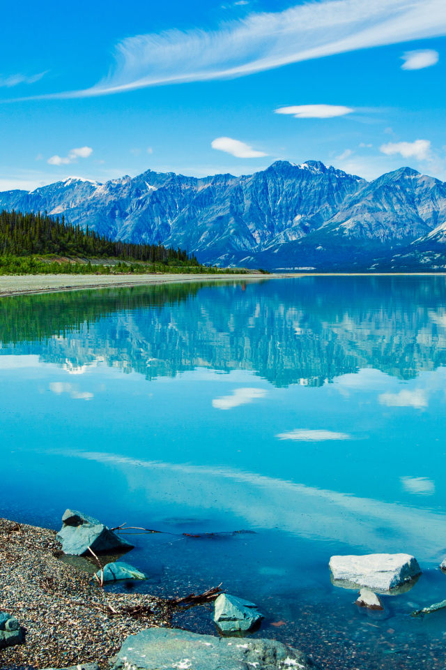 Красивое голубое озеро у заснеженных гор