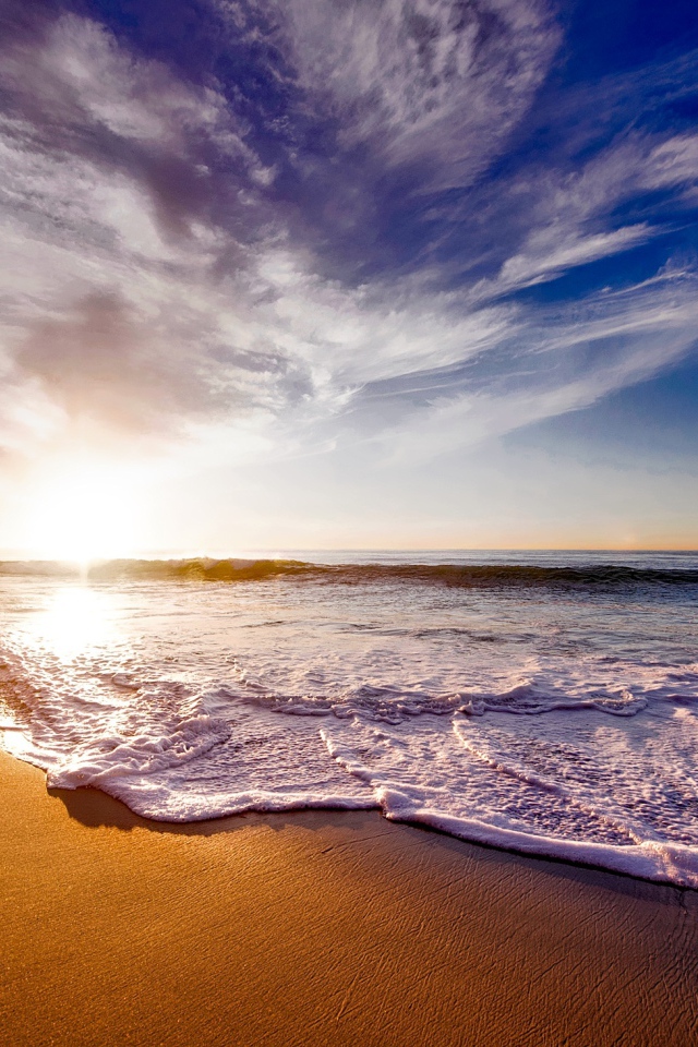 Красивые белые морские волны на теплом песке летом