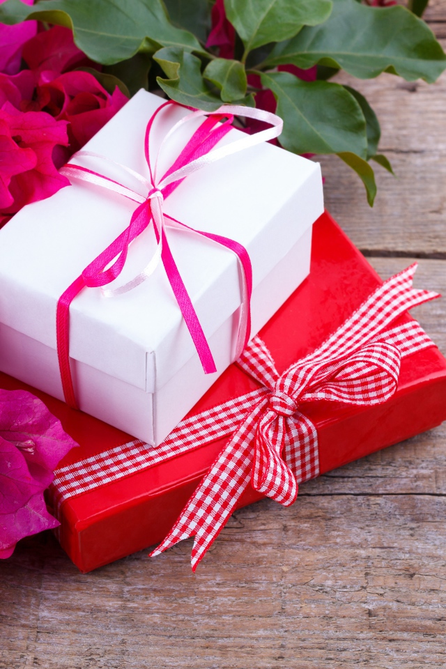 Две коробки с подарками на столе с цветами