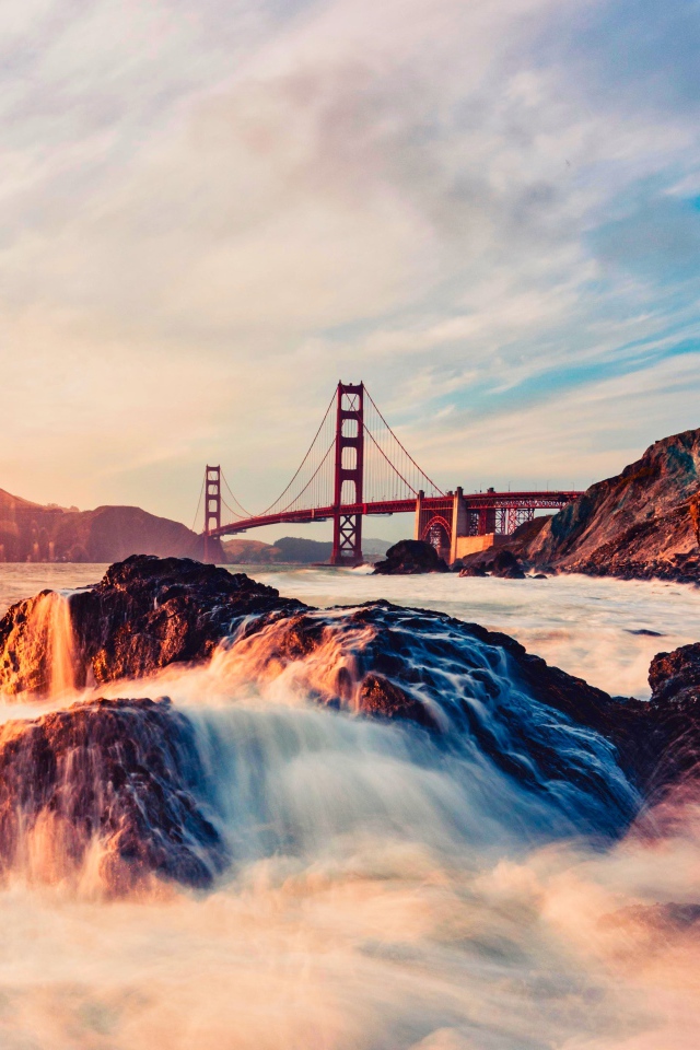 Golden Gate Bridge over a fast river in the sun