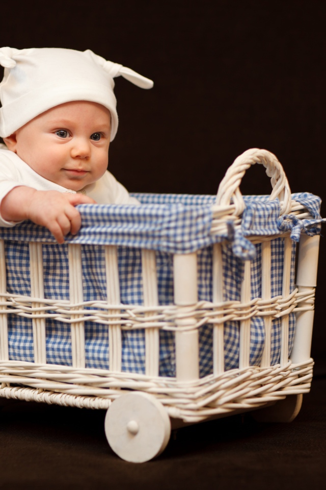 Маленький ребенок в кроватке на колесах 