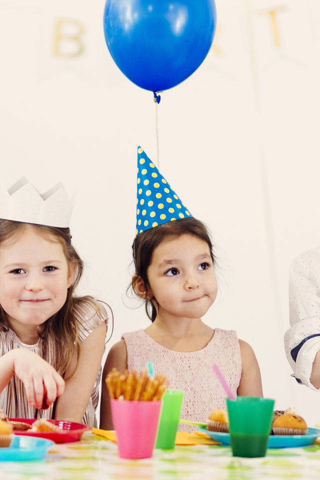 Маленькие дети отмечают детский праздник за столом