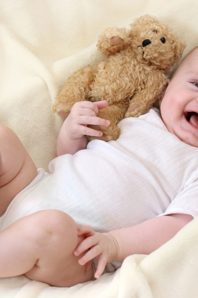 Улыбающийся малыш с медвежонком Тедди 