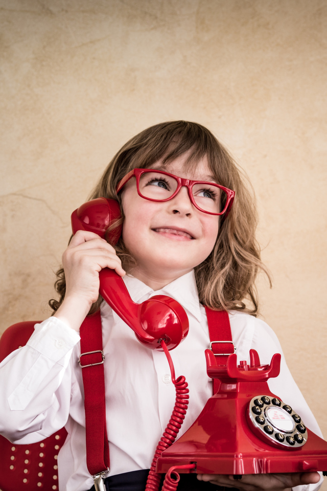 Улыбающийся мальчик с красным телефоном