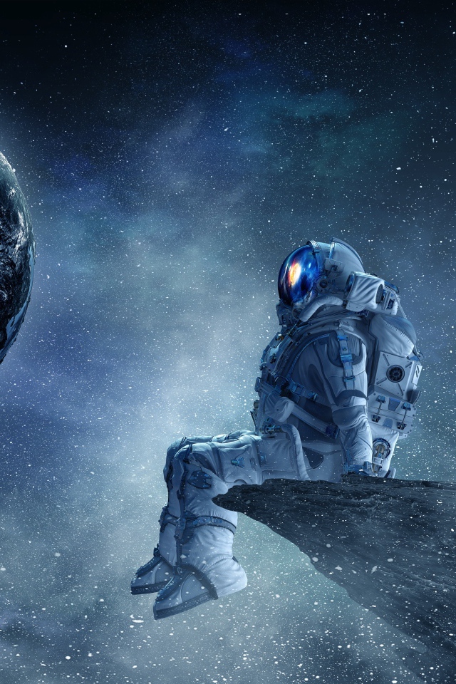 Мужчина астронавт смотрит на планету земля из космоса 