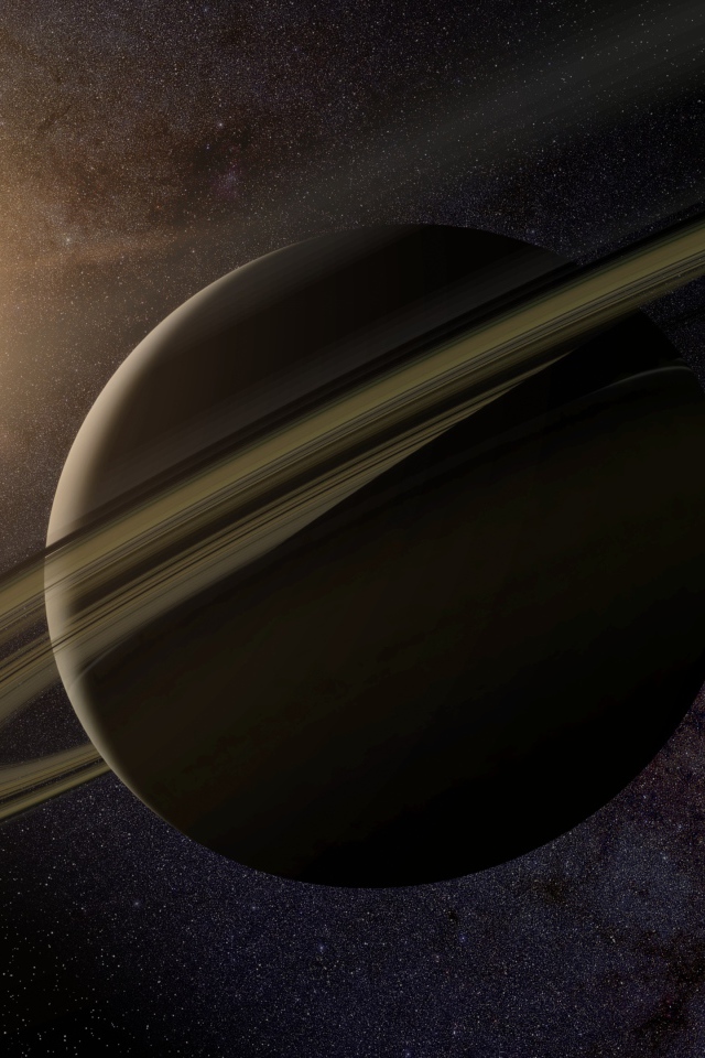 Планета Сатурн с кольцами на фоне солнца