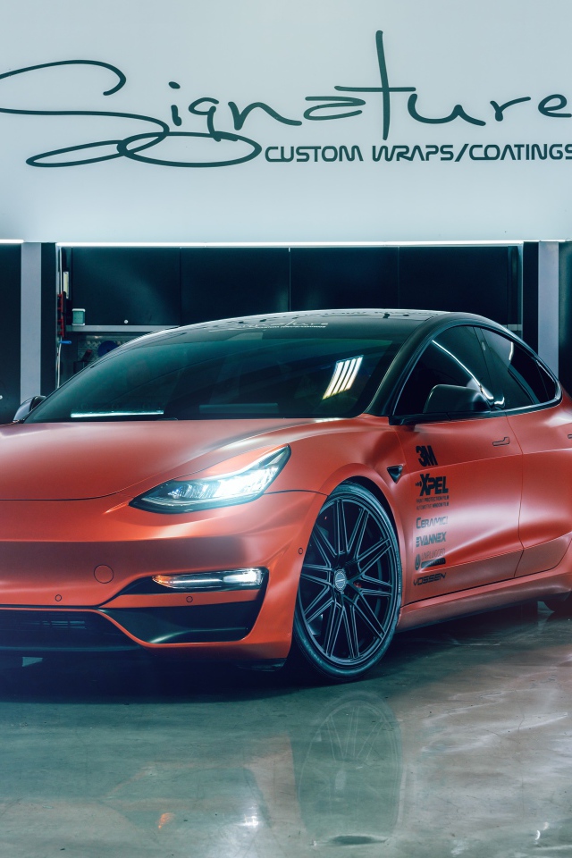 Красный автомобиль Tesla Model 3 в гараже