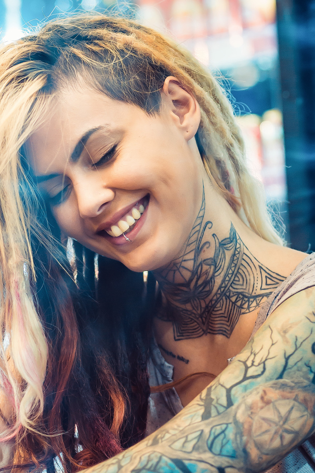 Smiling girl with tattoos on her body