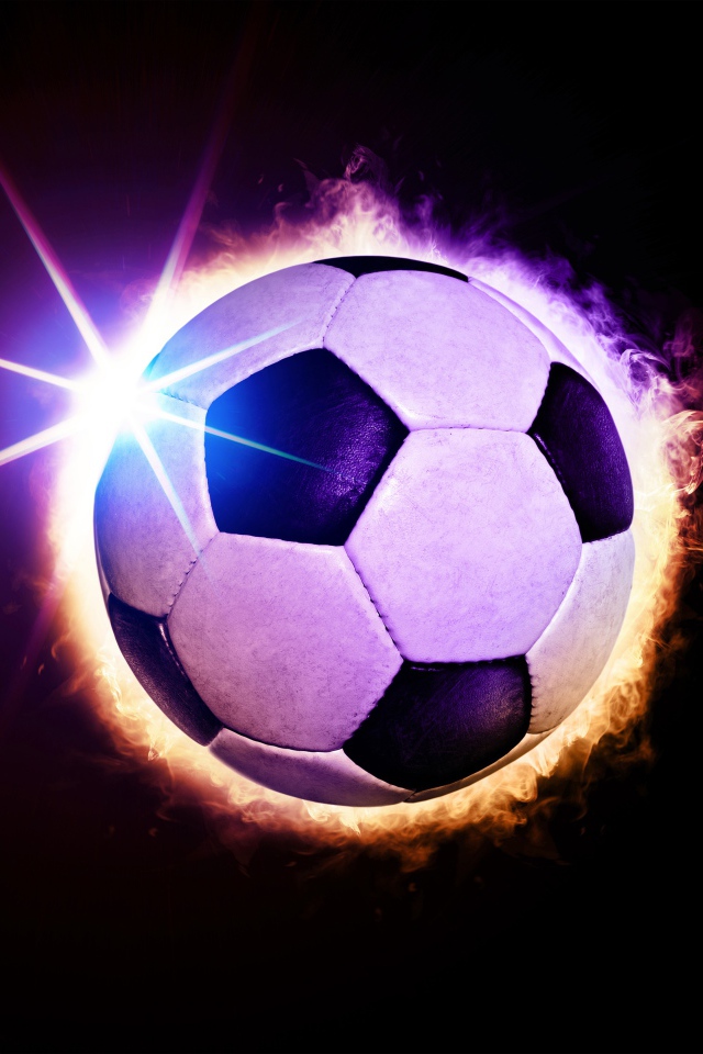Soccer ball in ring of fire on black background