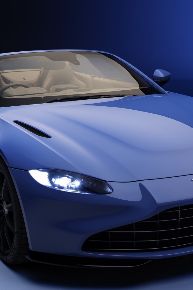 Кабриолет Aston Martin Vantage Roadster 2020 года на синем фоне