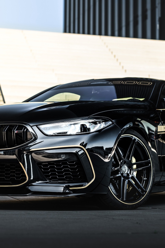 Черный автомобиль BMW Manhart MH8 800 2020 года у лестницы 