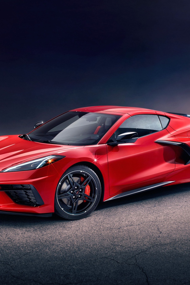 Красный автомобиль Chevrolet Corvette Stingray Z51 Preserial  на сером фоне