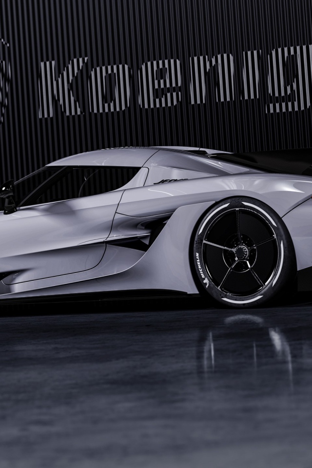 Автомобиль Koenigsegg Jesko Absolut 2020 года на фоне логотипа