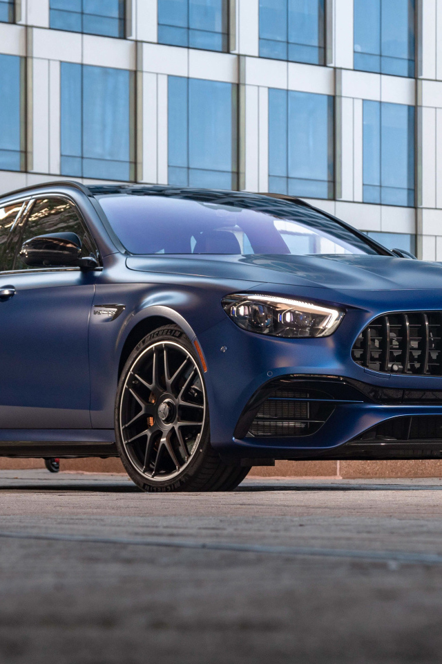 Синий автомобиль Mercedes-AMG E 63 S 4MATIC+, 2021 года на фоне дома