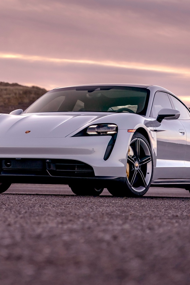 Серебристый автомобиль Porsche Taycan Turbo S 2020 года на фоне неба