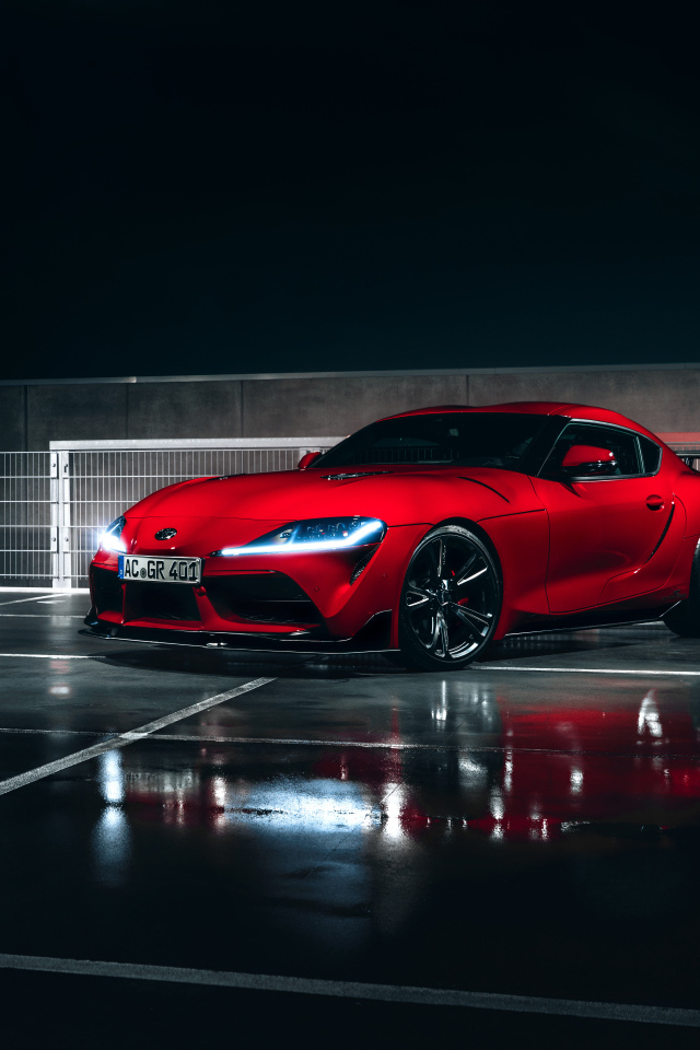 Красный автомобиль Toyota GR Supra AC Schnitzer 2019 года у гаража