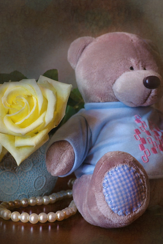 Big teddy bear with a bouquet of yellow roses