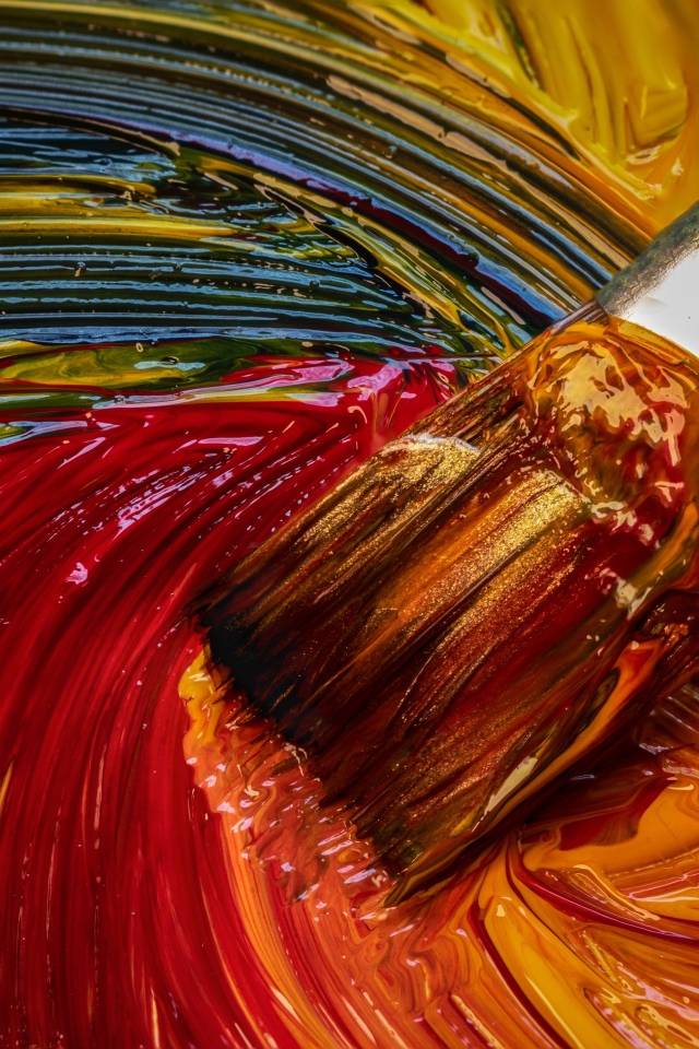 Brush mixes paints in a palette