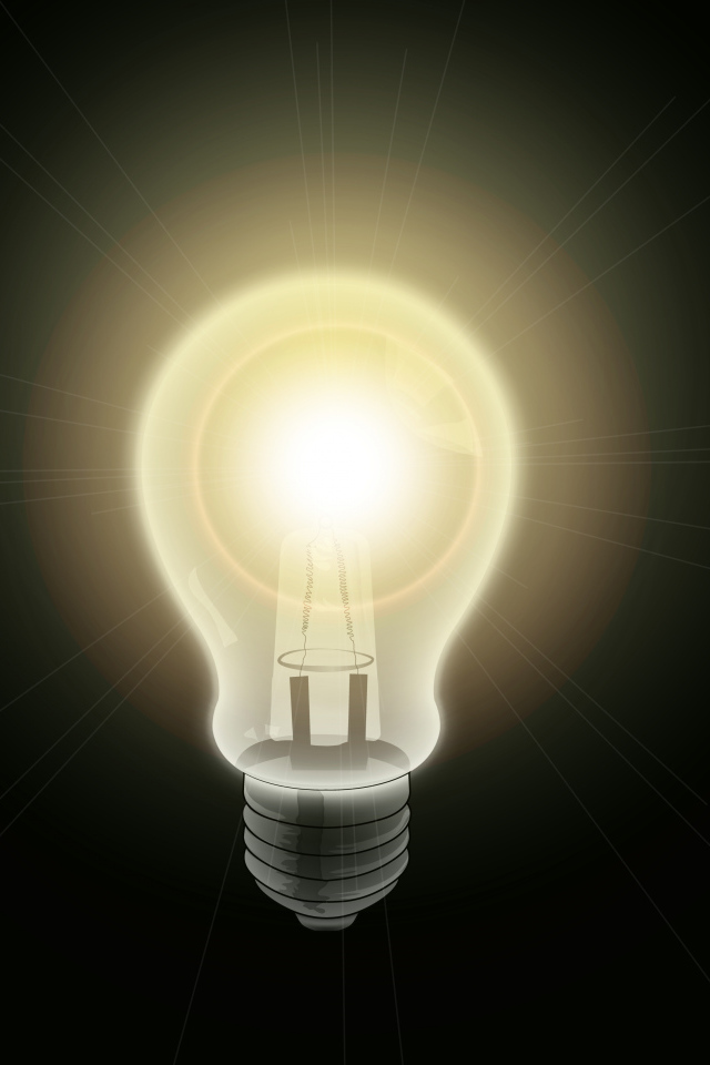 Зажженная лампа накаливания на черном фоне