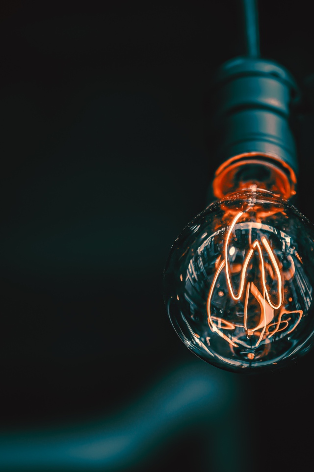 Зажженная лампа накаливания под потолком