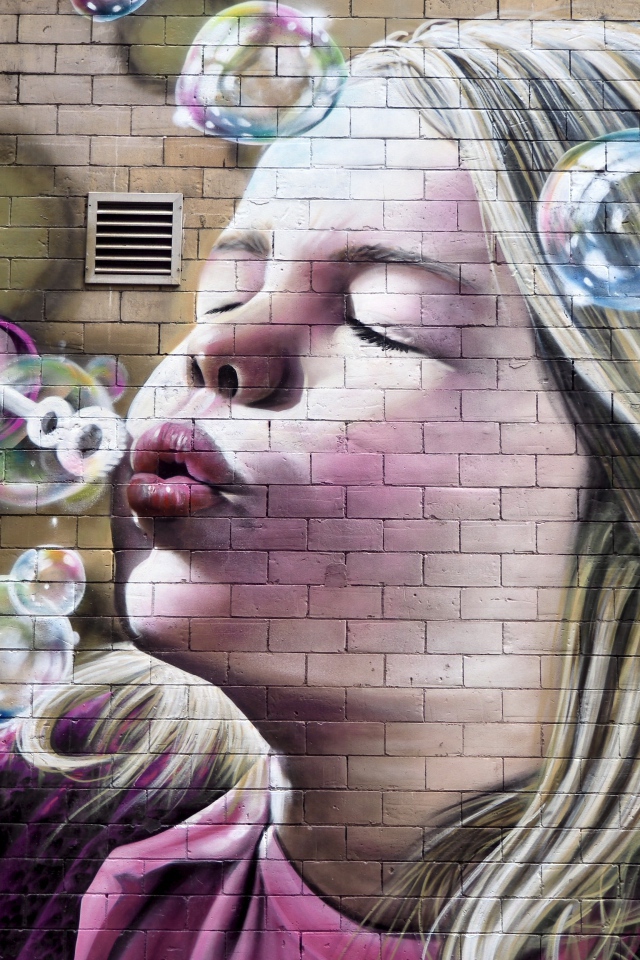 Girl with soap bubbles is painted on the wall.