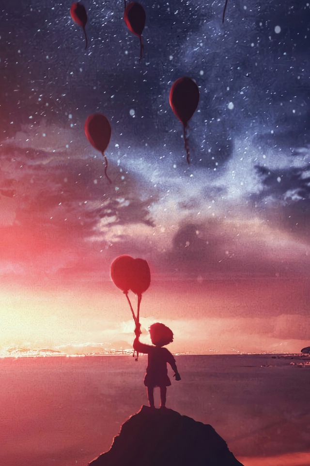Маленький мальчик запускает в ночное небо воздушные шары на берегу реки