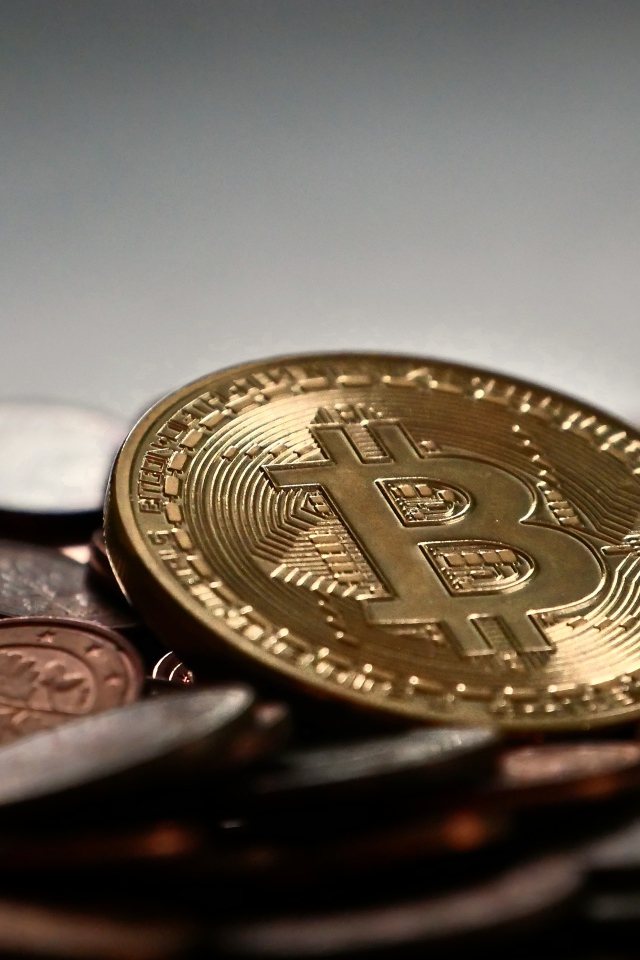 Bitcoin coin lies on old coins