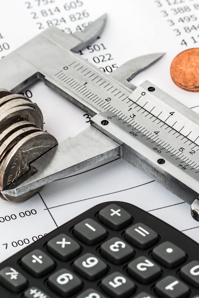 Coins on the table with caliper and calculator