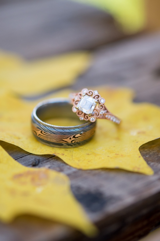 Золотые кольца с желтым листом на столе 