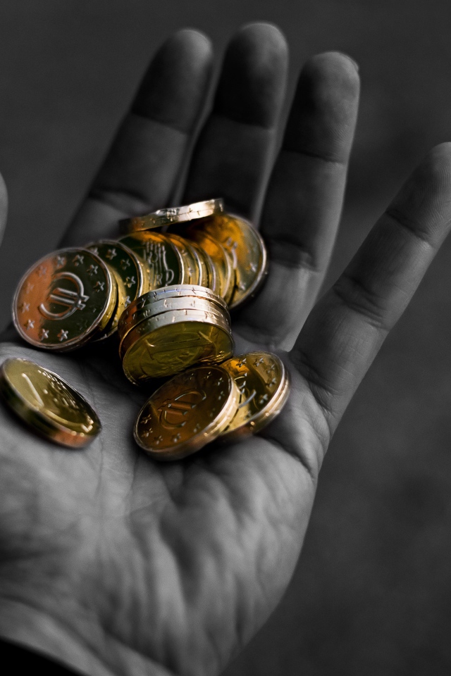 Много монет в руке у мужчины