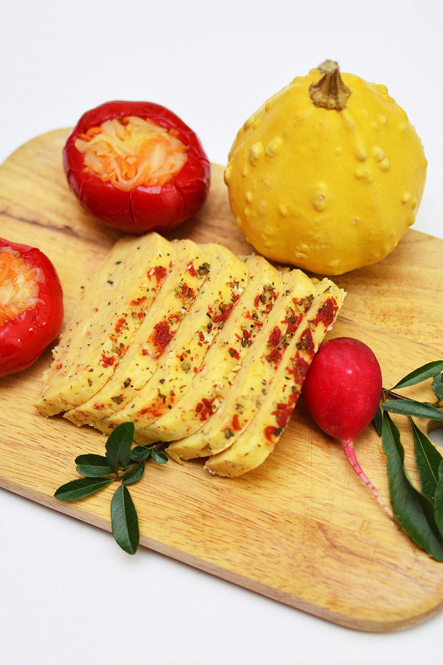 Сыр с овощами на разделочной доске на белом фоне