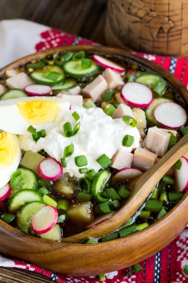 Холодная окрошка в деревянной миске на столе 