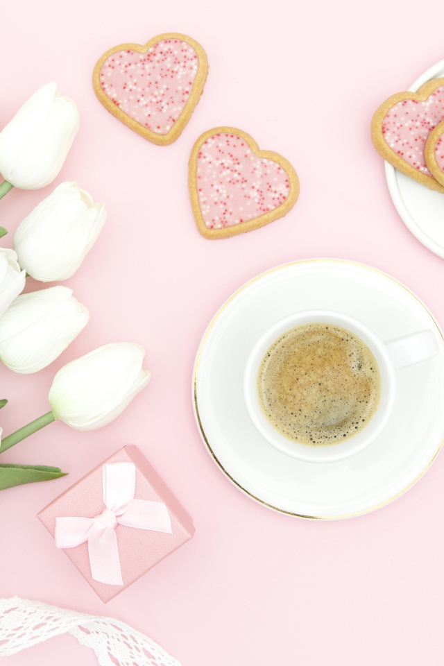 Чашка кофе с печеньем на столе с букетом белых тюльпанов