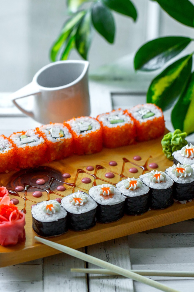 Вкусные суши и роллы на столе с имбирем
