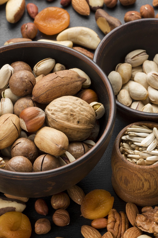 Different types of nuts on the table in bowls