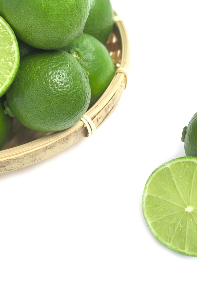 Кислые плоды зеленого лайма на белом столе