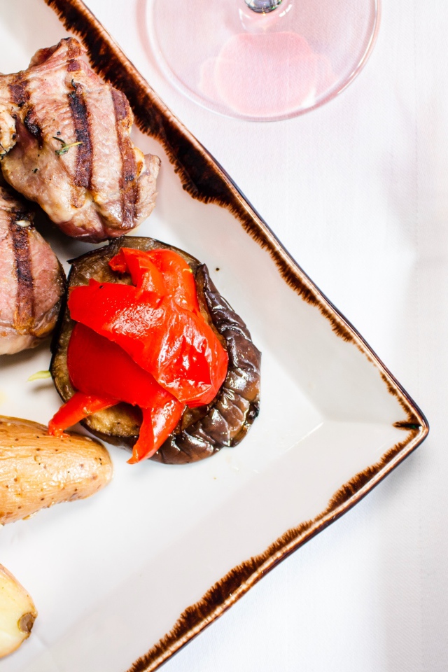 Свиные ребрышки с овощами на столе 