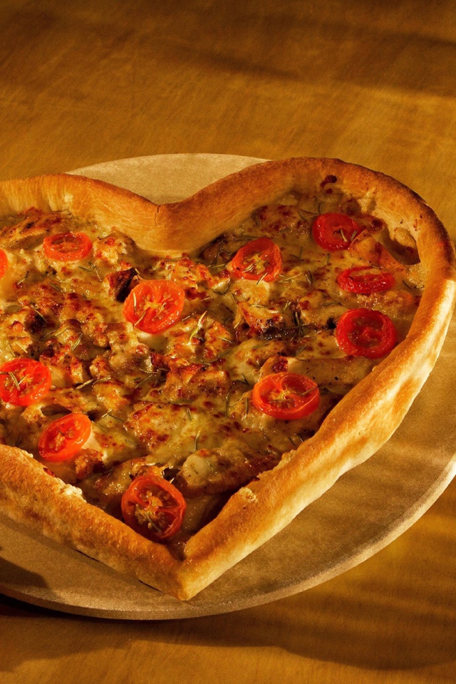 Пицца в форме сердца на столе с розой и двумя бокалами вина