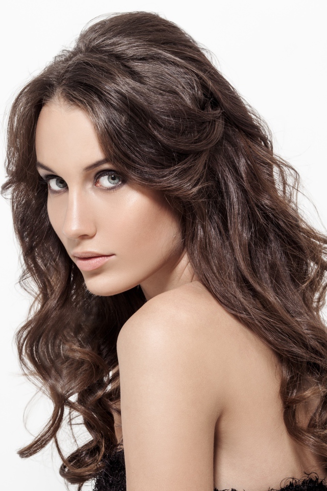 Красивая длинноволосая девушка шатенка на белом фоне 