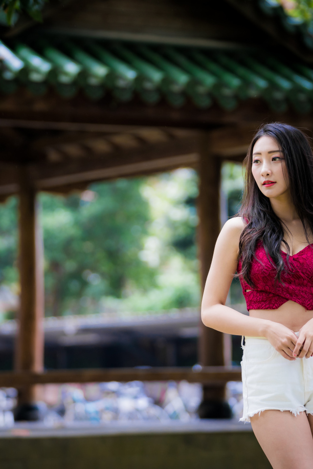 Красивая девушка в белых шортах в парке